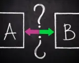 Dwa pola z literami A i B, połączone strzałkami i znakami zapytania. Symbolizuje to proces decyzyjny, jak w alpha testing.