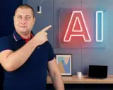 Mężczyzna wskazuje na neonowe logo AI, sugerując rozpoczęcie kursu QA z naciskiem na sztuczną inteligencję.
